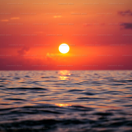 Sun setting over deep ocean water in The Bahamas.