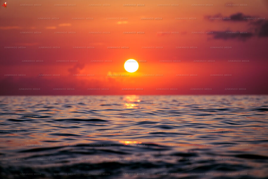 Sun setting over deep ocean water in The Bahamas.