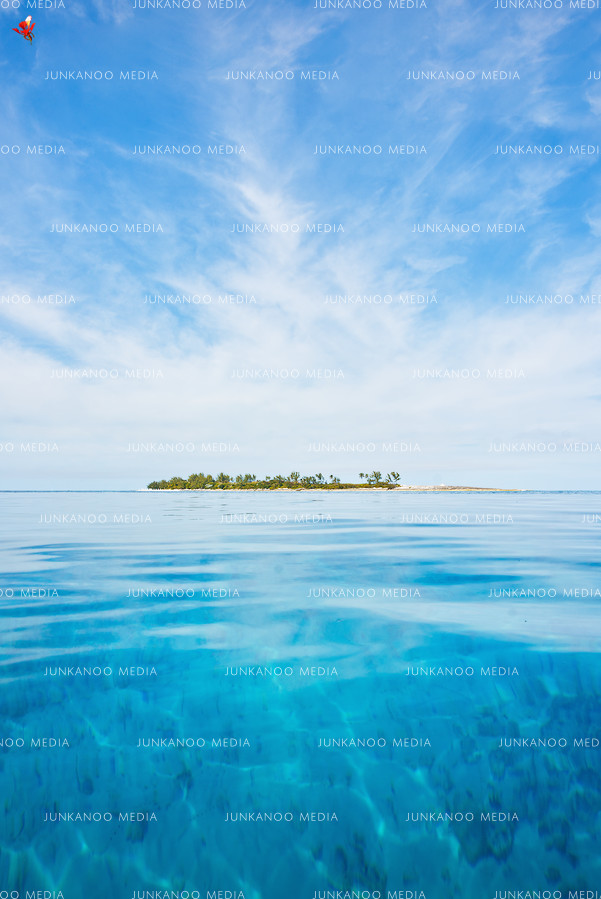 Turquoise waters and a blue sky surround Long Cay in The Bahamas.