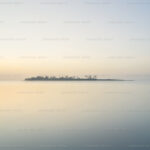 Grey mist surrounds an island frozen in time.