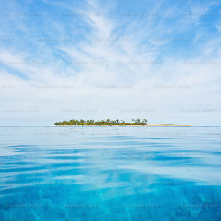 Turquoise waters and a blue sky surround Long Cay in The Bahamas.