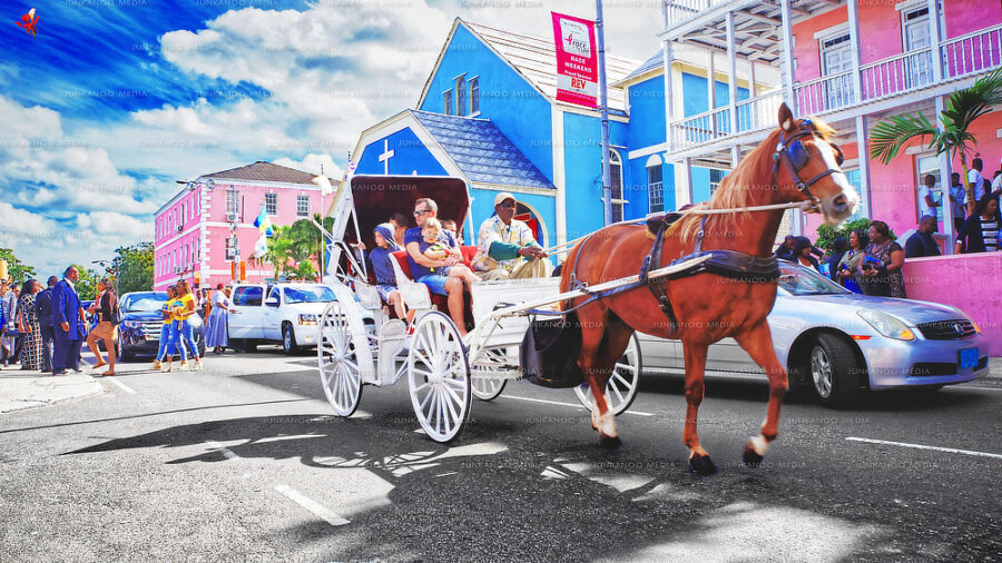 A horse drawn carriage pulls tourists and a driver down Shirley street in front of Zion Baptist Church.