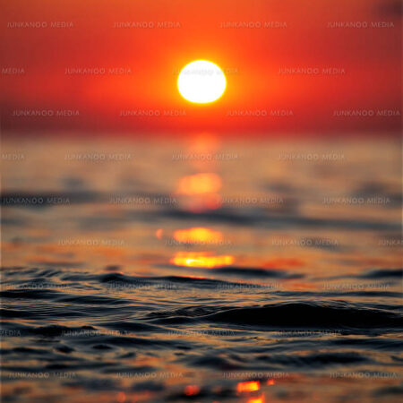 Sunset over ocean tides in Nassau, Bahamas.