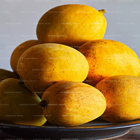 Dinner plate stacked with Bahamian mangoes.